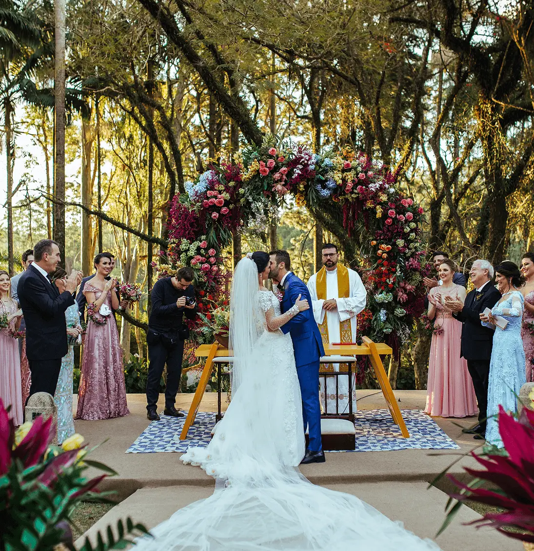 Bride and groom kissing at outdoor wedding.